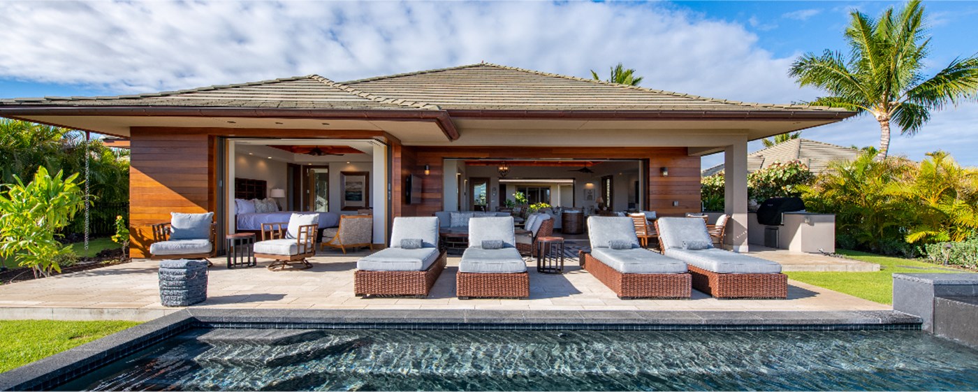 Naupaka home outdoor lounge area with chairs placed poolside