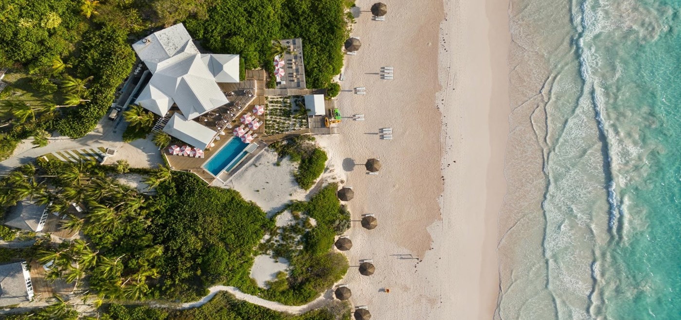 Aerial view of resort, pool, beach, and ocean