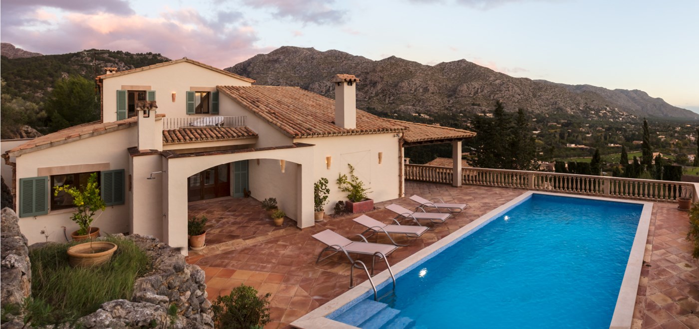 Backyard pool with lounge chairs at Inspirato home Villa Ladera